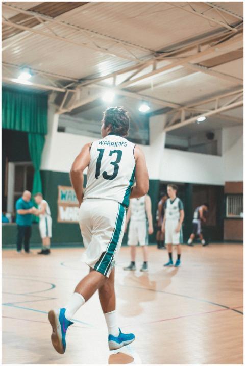 Dynamic indoor basketball scene with players in ac