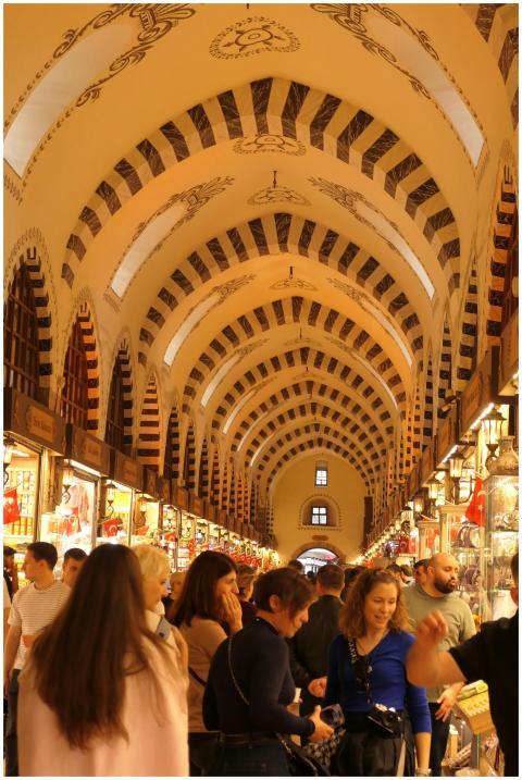 Bustling crowd under arched ceilings in a historic