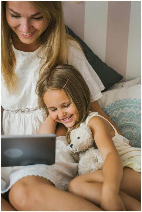A joyful mother and daughter bonding over a tablet