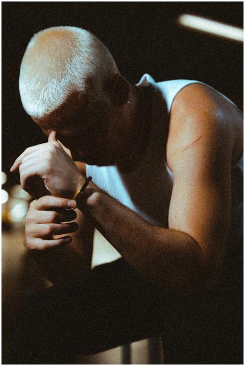 Portrait of a man in a tank top, deep in thought,