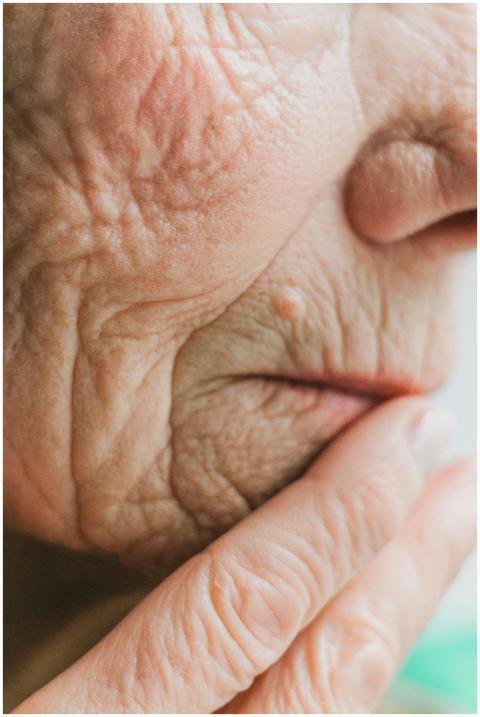 Detailed close-up of a senior adult's face and han