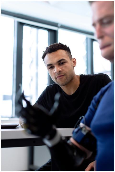 An engineer discusses a robotic prosthetic arm in
