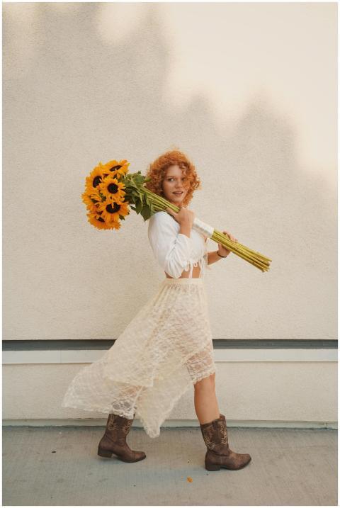 Charming woman with curly hair in a lace dress car