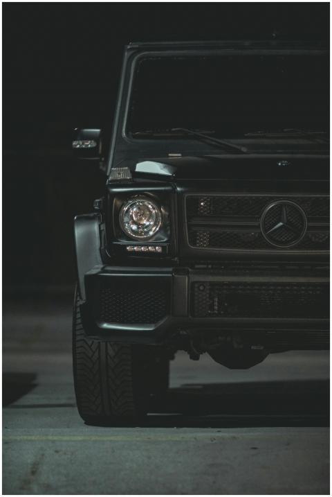 Close-up of a luxury black car's front, featuring