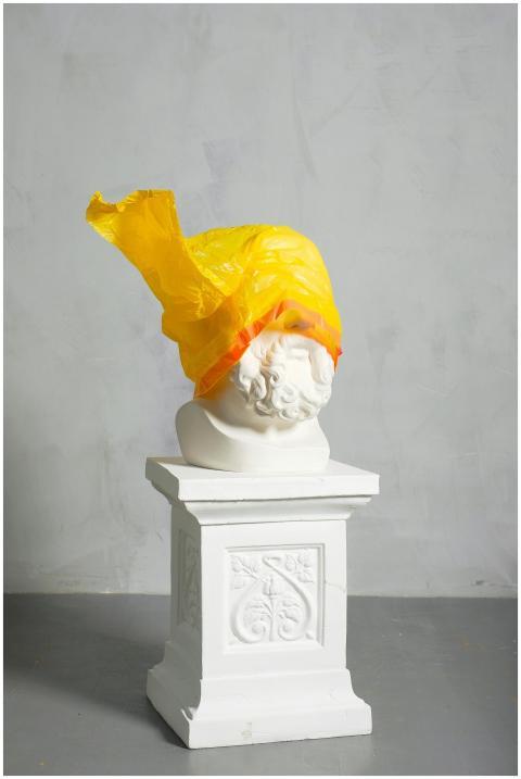 A classic sculpture covered with a yellow plastic