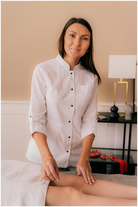 Female acupuncturist performing treatment in a mod