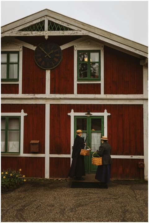 Historical Swedish house with two people in tradit