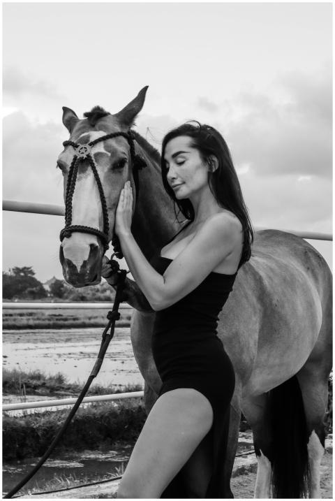 Elegant woman in a stylish black dress posing with