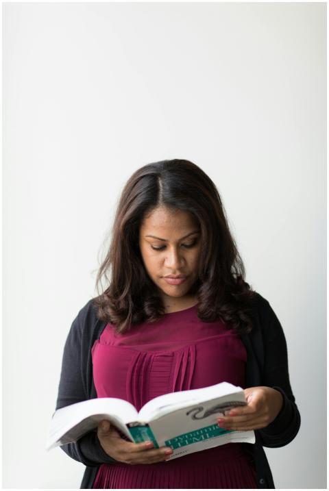 Focused woman reading a book indoors, conveying le