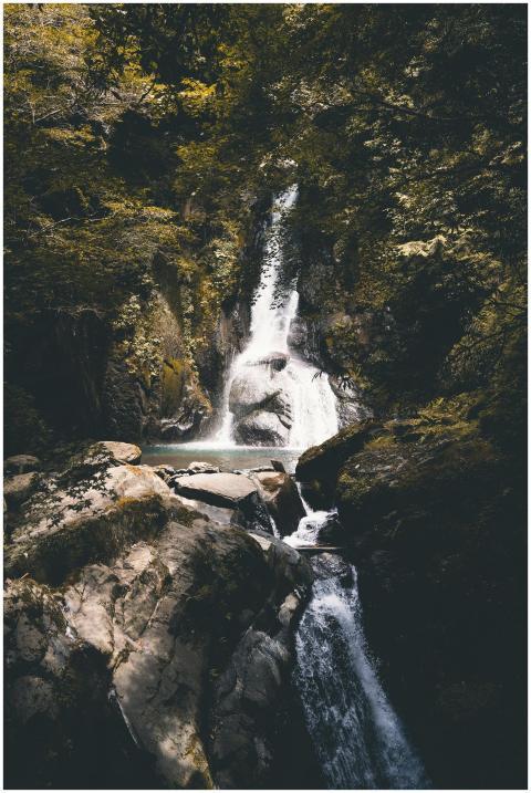 Tranquil waterfall cascading in a rocky plunge poo