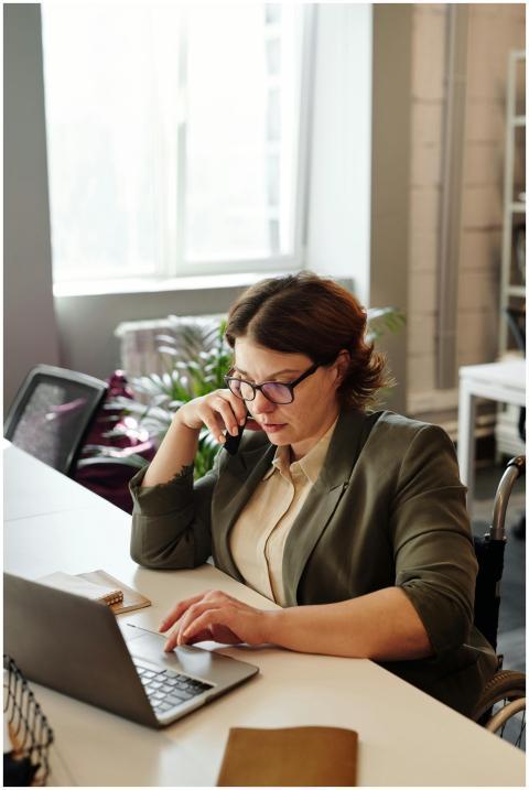 Businesswoman in a wheelchair working from home of