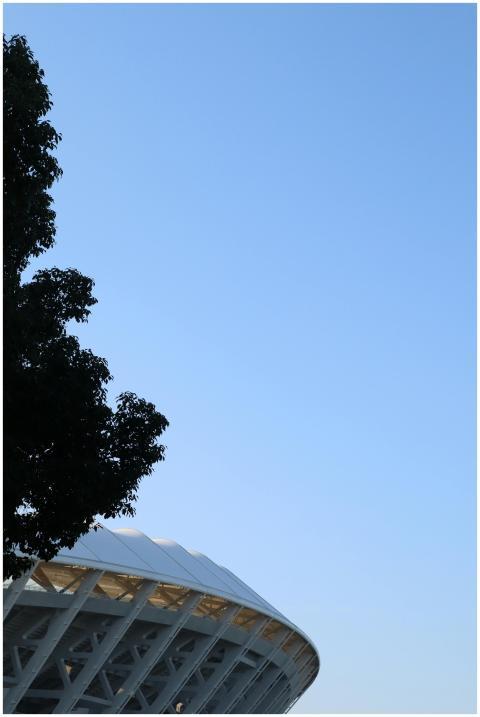 Partial view of a modern stadium roof with clear b