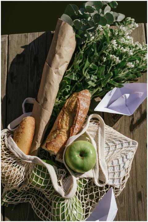 Picnic arrangement featuring fresh bread, green ap