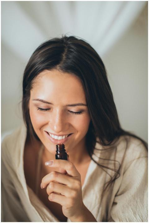 A smiling woman with closed eyes enjoying the scen