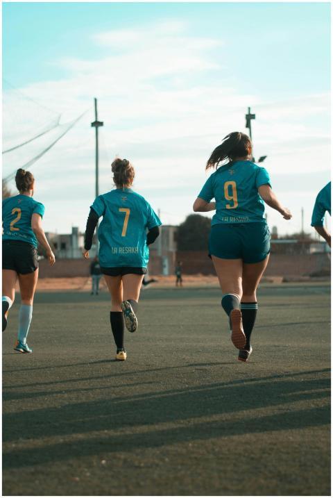 Women soccer team in action on the field during da