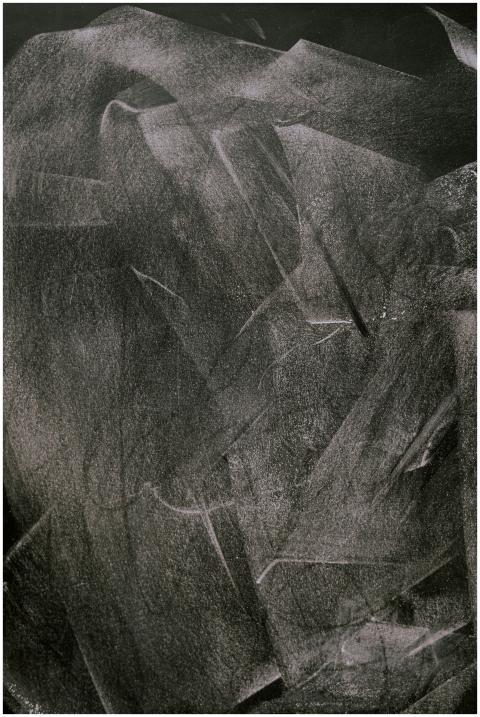 Abstract texture of chalk marks erased on a dark s