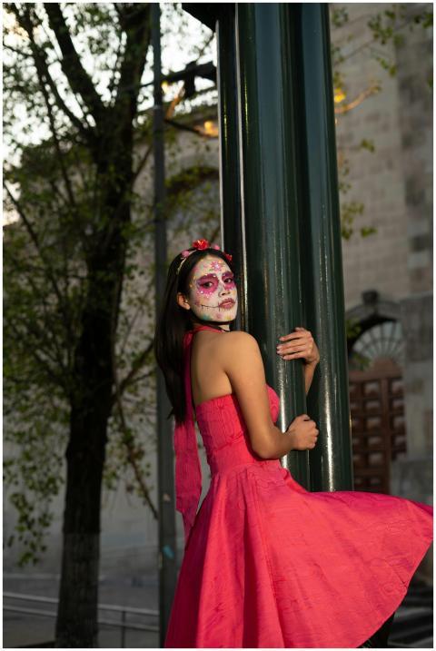 A young woman with Día de los Muertos makeup in a