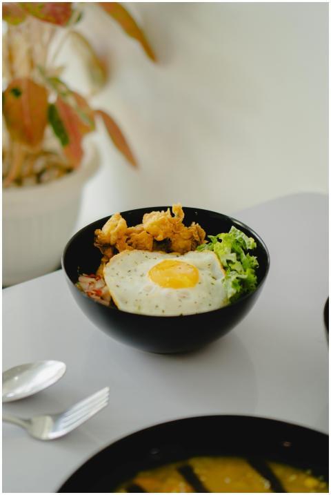 A tempting Indonesian rice bowl featuring a sunny-