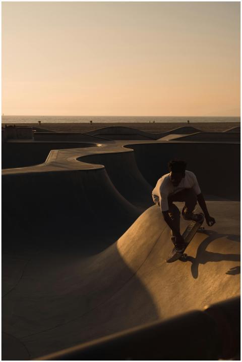 Silhouette of a skateboarder at sunset in a Los An