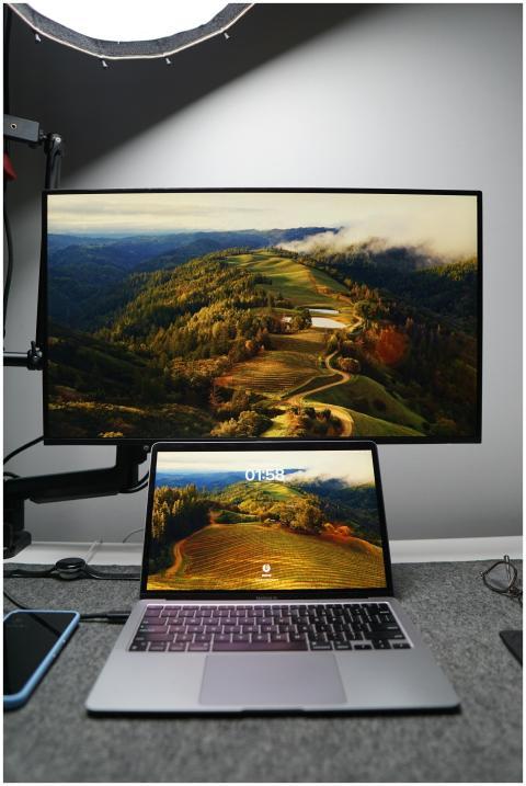 A home office setup featuring a laptop and monitor