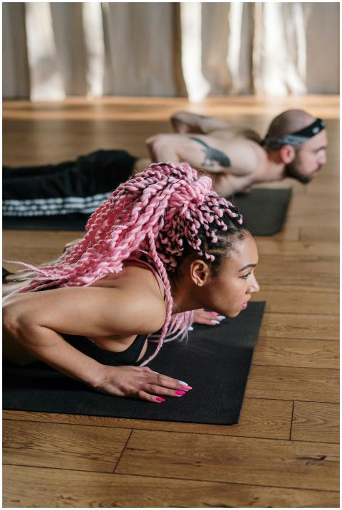 A diverse group of adults practicing yoga on mats