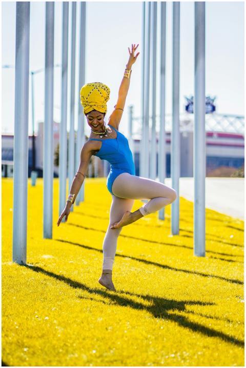 Elegant ballet dancer in bright attire strikes a p