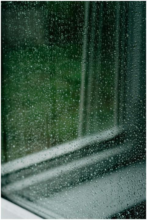 Close-up of a window with raindrops creating a soo