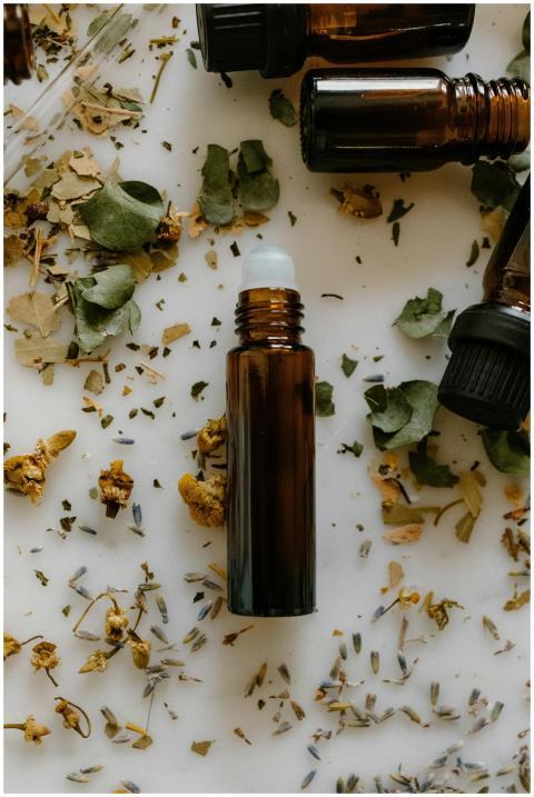 A flat lay of essential oil bottles surrounded by