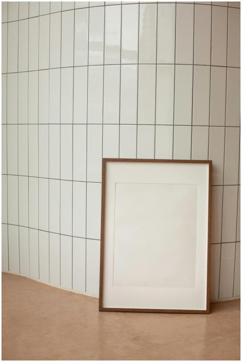 A minimalist interior featuring a blank vertical f