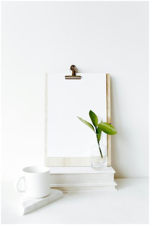Composition of clipboard with empty sheet placed o