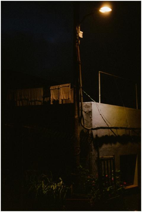 A streetlight illuminates a rural scene with dryin