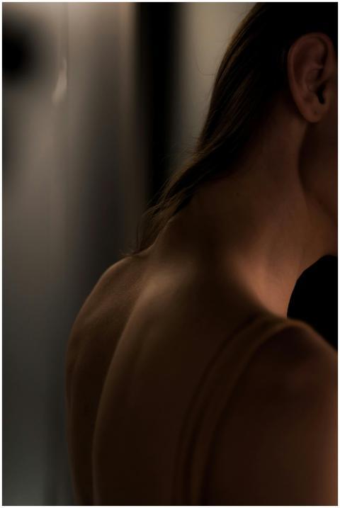 Artistic close-up of a woman's back and neck, crea