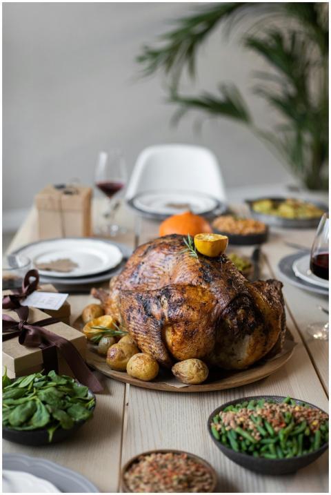 A beautifully set Thanksgiving dinner table featur