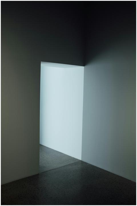 Moody, minimalist hallway with distinctive doorway