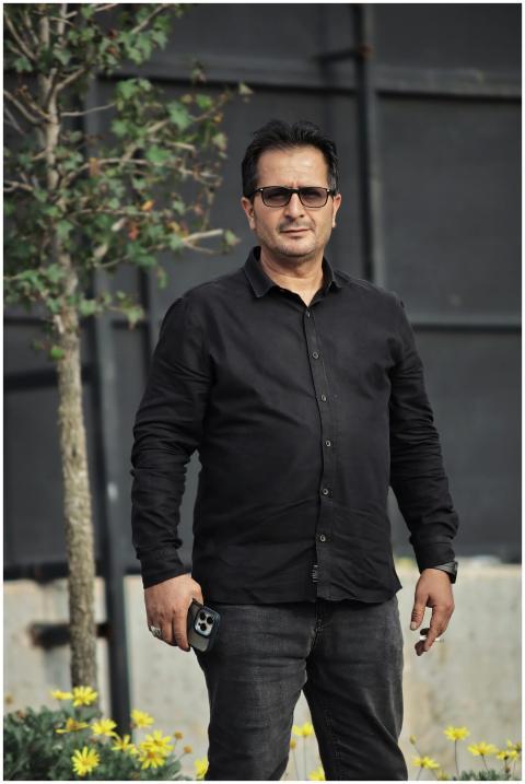 Casually dressed man with glasses standing outdoor