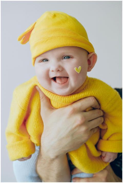 Adorable baby wearing a yellow beanie with a heart