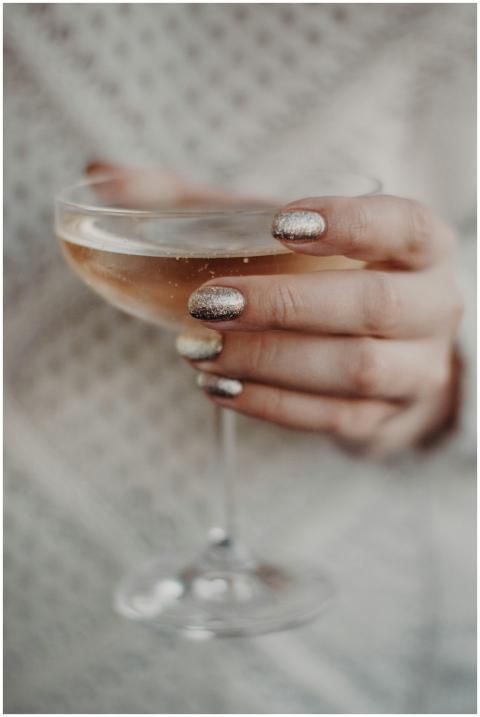 Elegant close-up of a woman's hand holding a glass