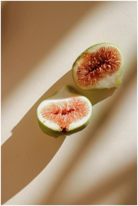 Close-up of a halved fig with visible seeds and ju
