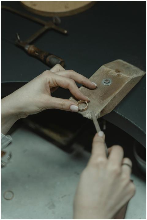 Close-up of a jeweler using hand tools to craft a