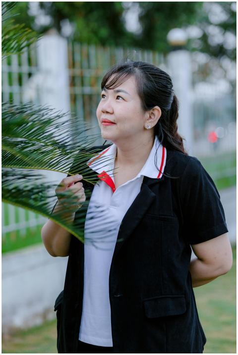 Woman Smiling Beside Green