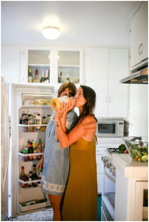 Two women having fun and sharing a drink in a styl
