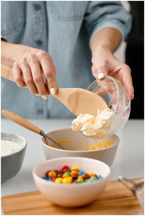 Close-up of hands adding butter for baking with co