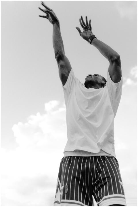 Black and white image of an athlete jumping and re