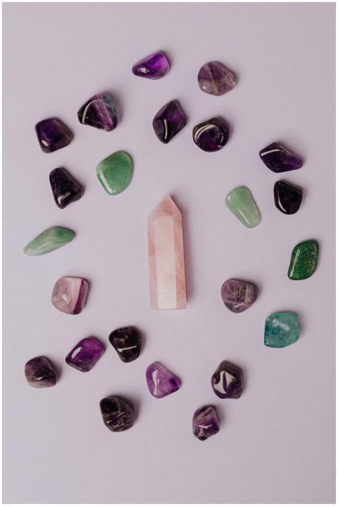 Flat lay of assorted gemstones and rose quartz on