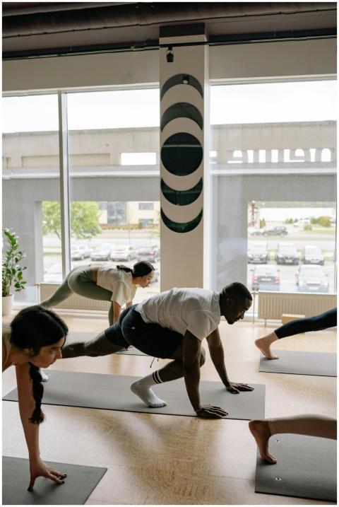 A diverse group of adults practicing yoga poses in