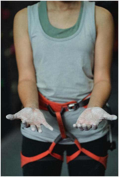 Close-up of a female climber's chalked hands, focu