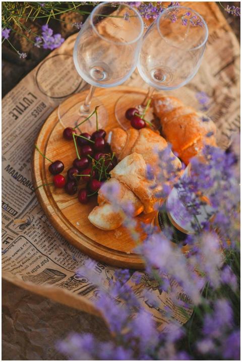 A rustic picnic scene with croissants, cherries, a