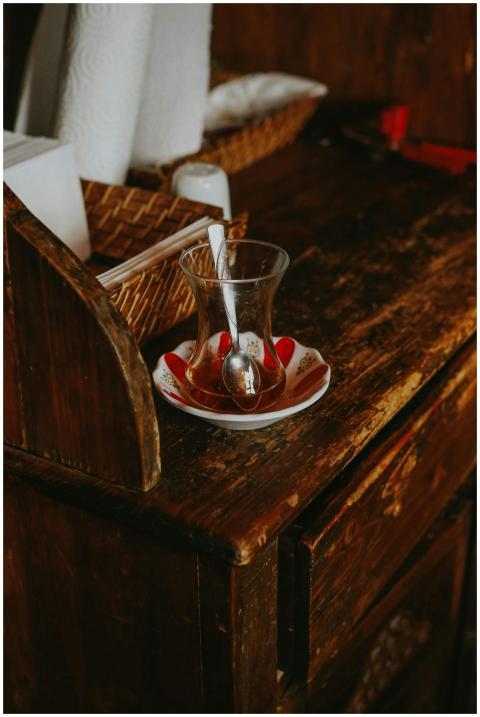 A glass of Turkish tea set on a vintage wooden tab