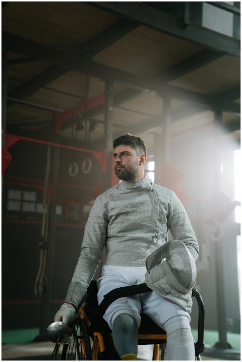 Wheelchair fencer in gear, focused and ready in an