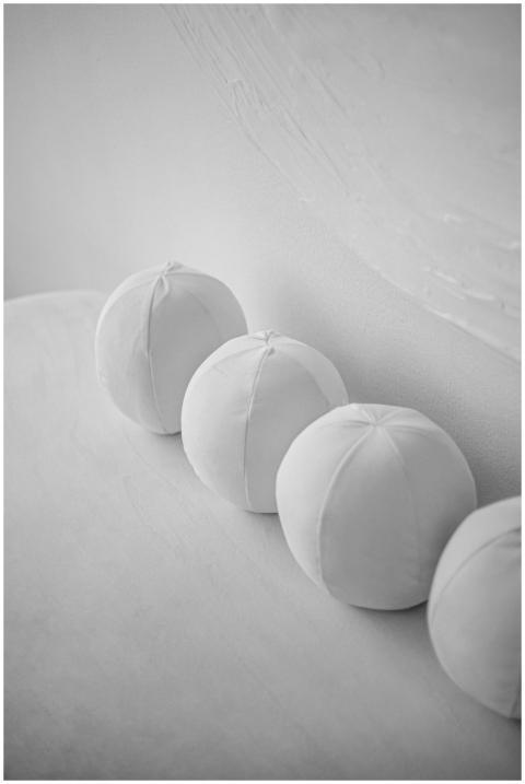 Monochrome image showcasing a row of spherical whi